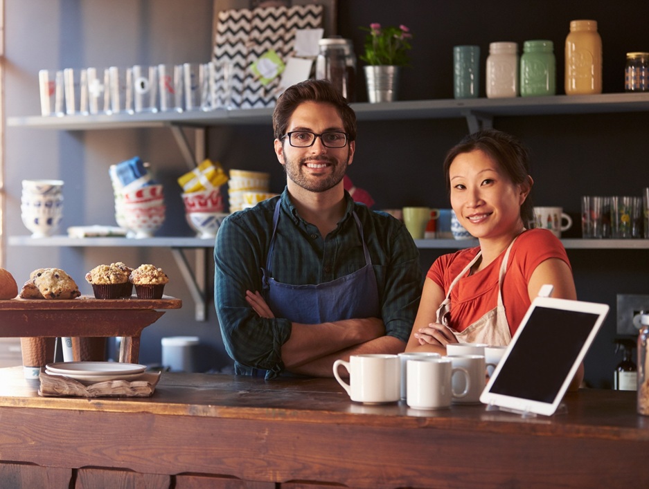 two professionals staring at the camera and smiling in a business setting