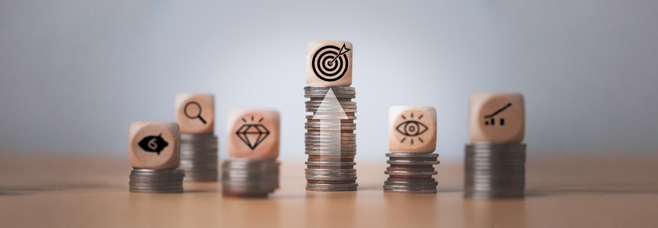 small blocks stacked on top of piles of coin currency