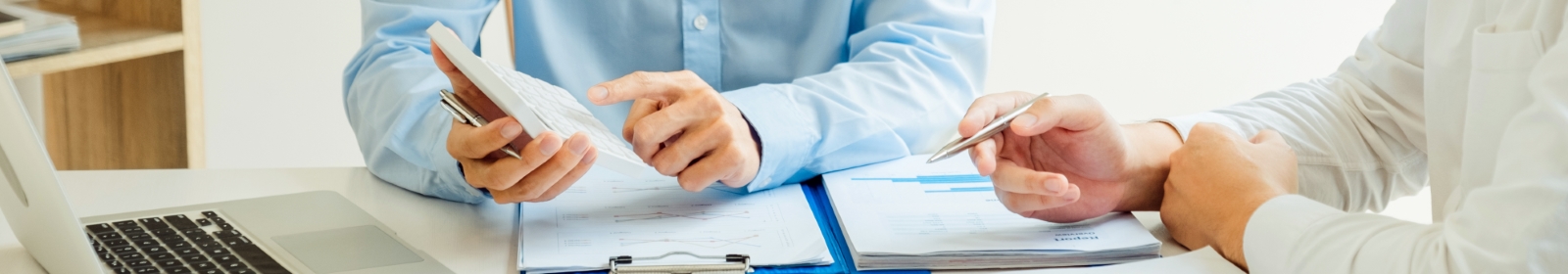 two professionals discussing business plans at an office table